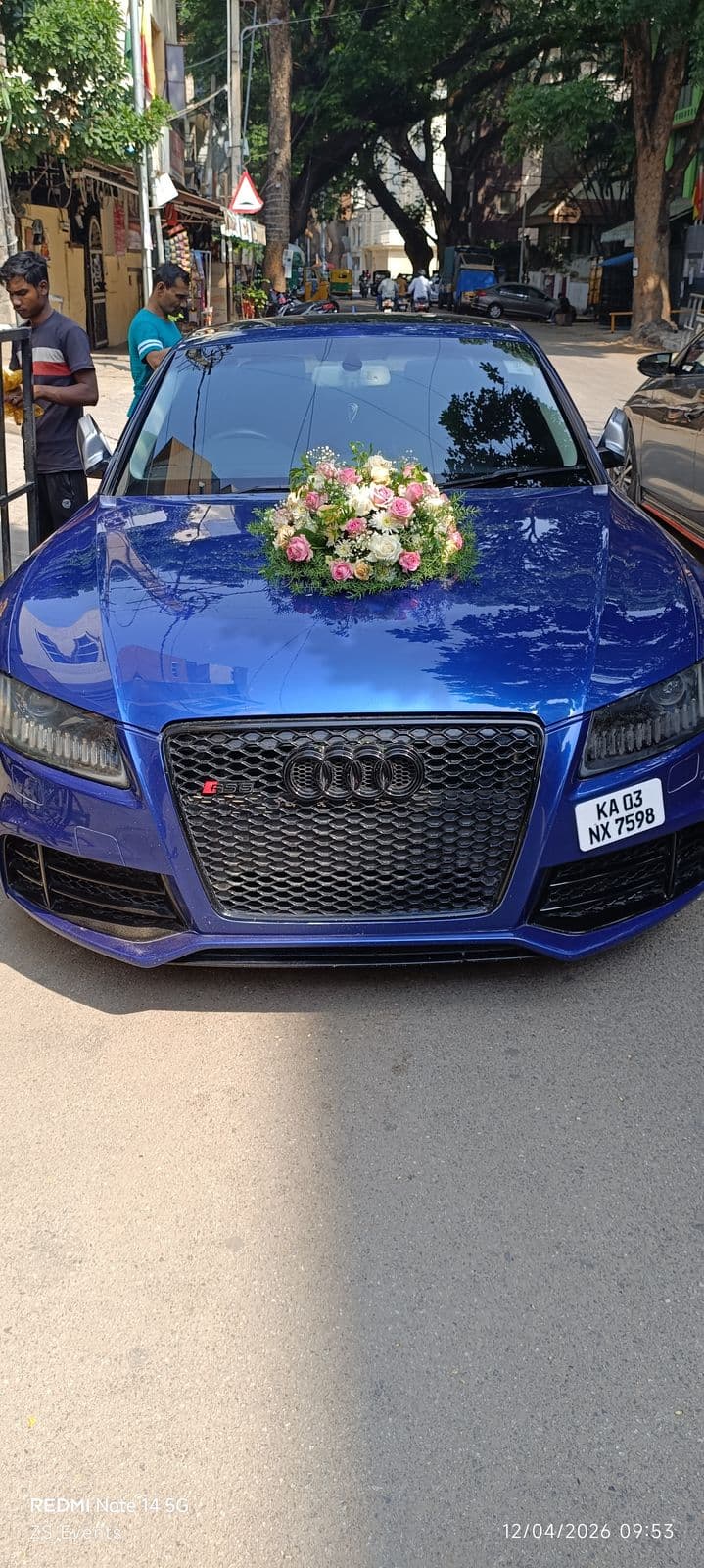 Blue Audi wedding car with fresh flower bouquet on the bonnet