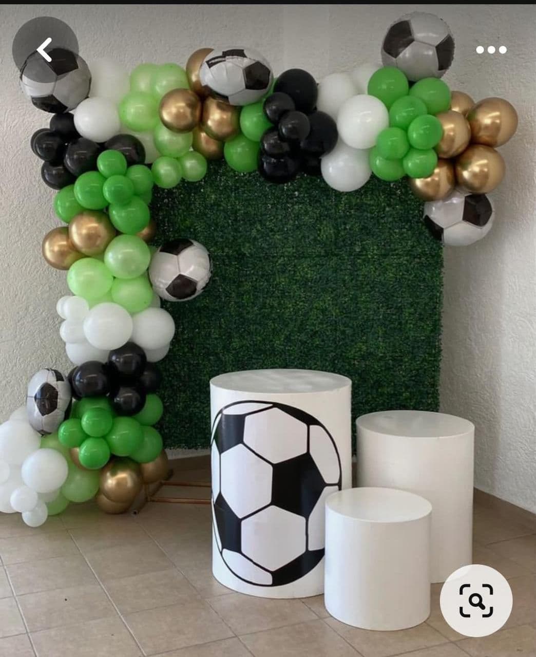 Football-themed birthday balloon garland in green, black and white