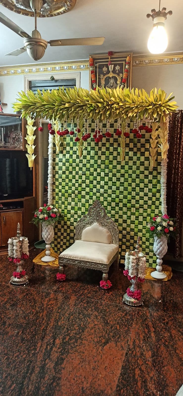 Green and yellow haldi mandap with marigold strings and bride's seat