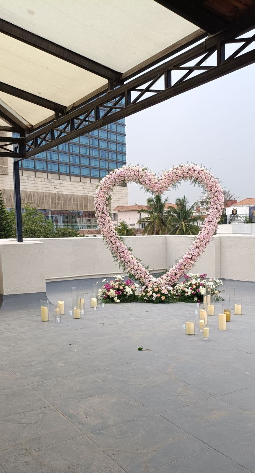 Pink rose heart arch and candle pathway on a rooftop