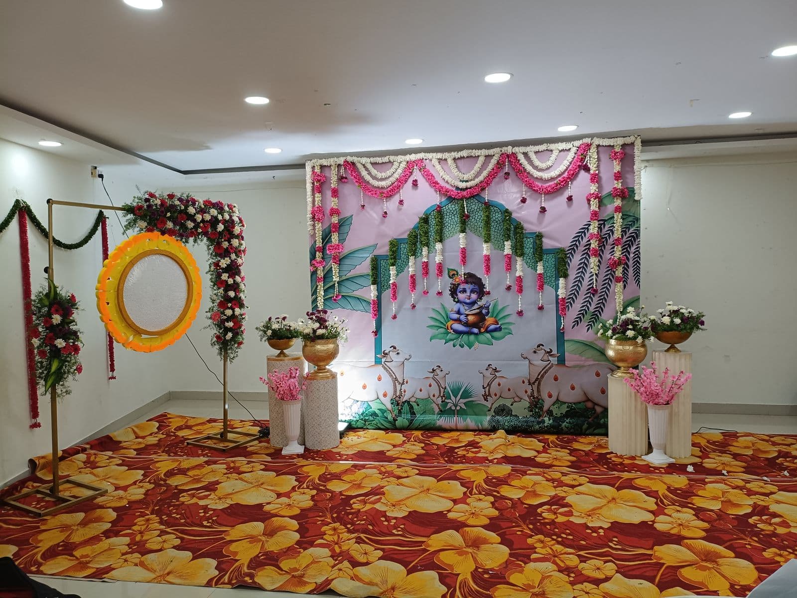 Wide view of a Krishna-themed naming ceremony setup