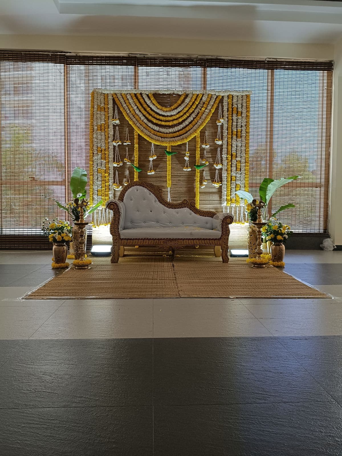 Wide view of a marigold mehendi backdrop with plants and chaise