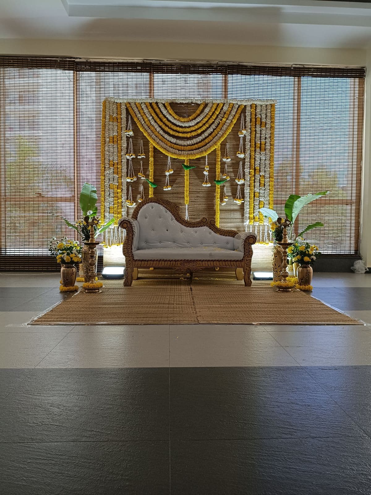 Marigold and mogra backdrop with white chaise for mehendi