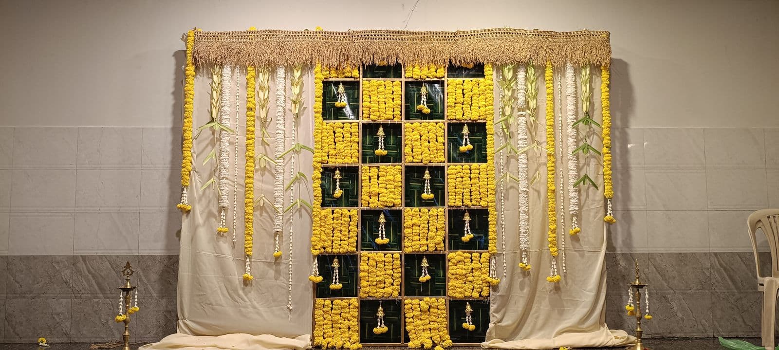 Yellow marigold and white jasmine panel backdrop with hanging strands