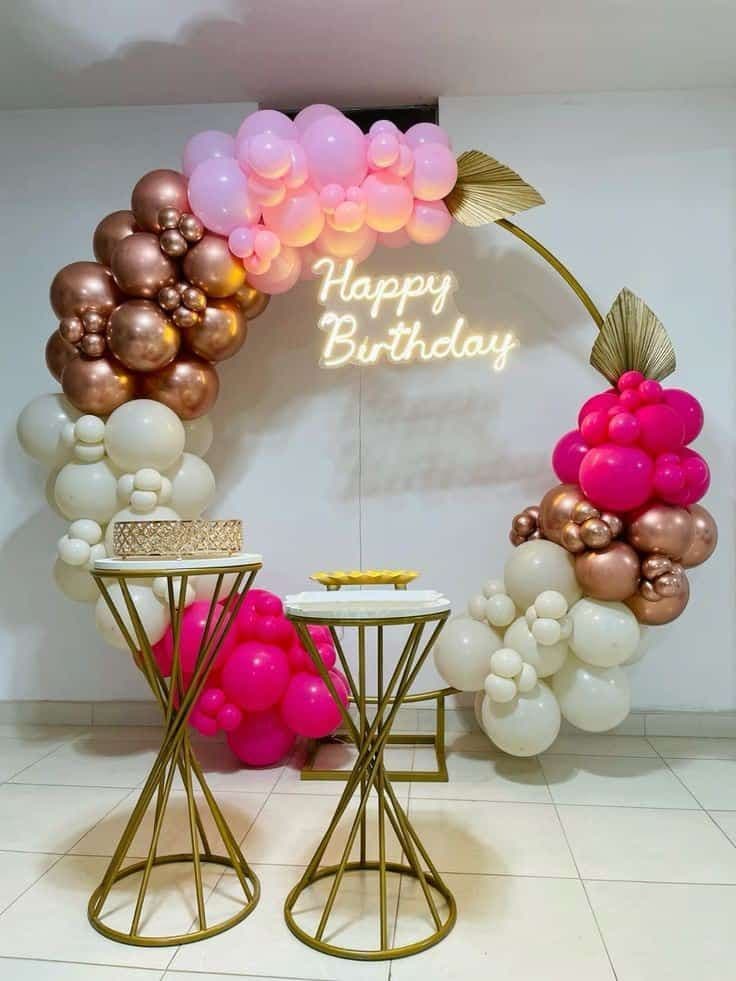 Pink, chrome and ivory balloon arc with Happy Birthday neon and gold plinths