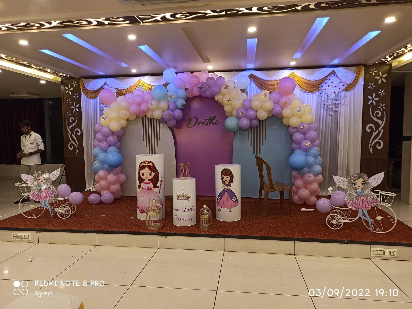 Princess-themed birthday backdrop with pastel balloon arch