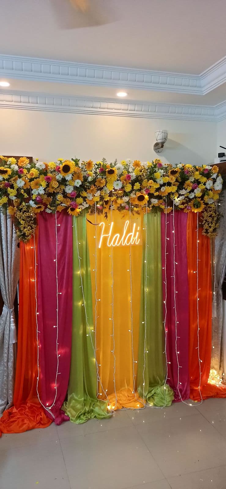 Rainbow drape haldi backdrop with sunflower top and Haldi sign