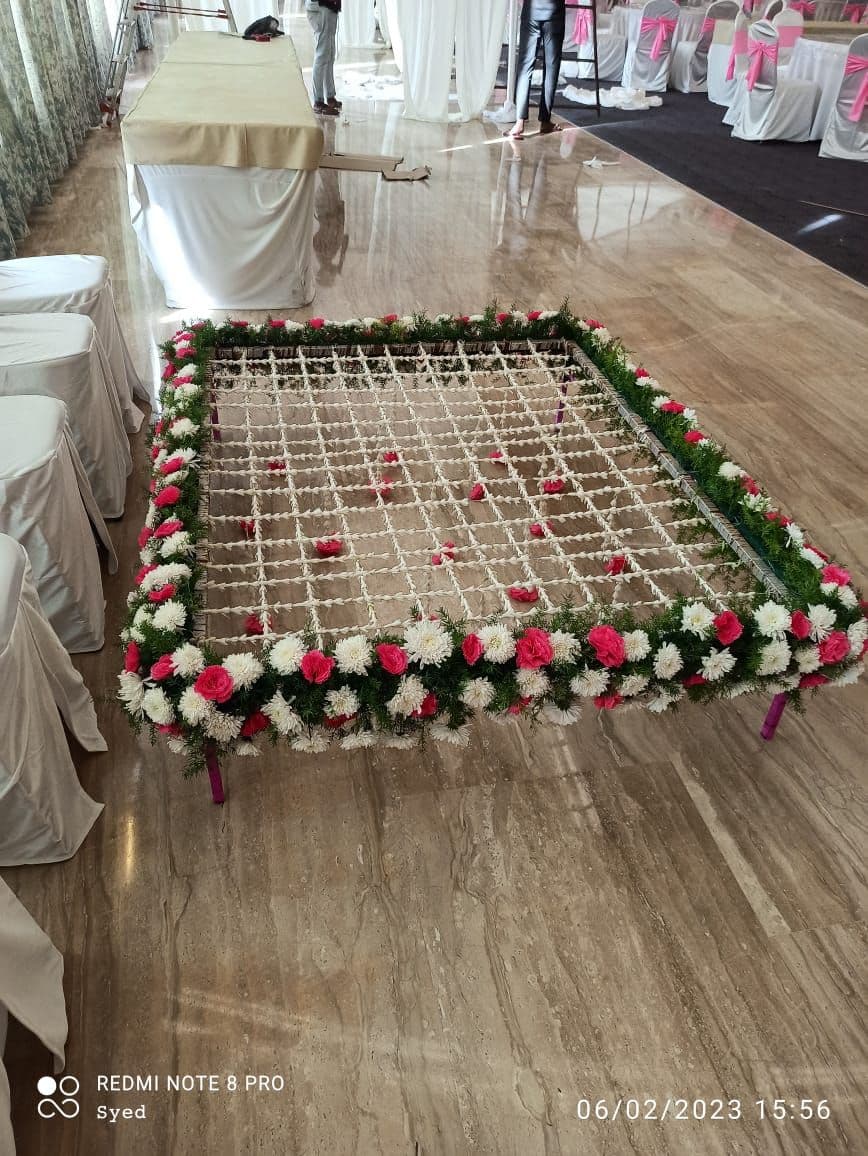 Red and white rose flower chadar on a banquet hall floor