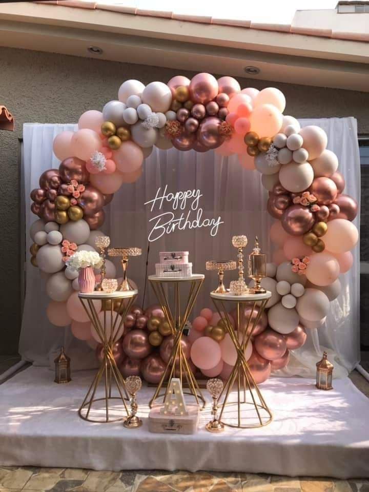 Rose gold and chrome balloon ring with Happy Birthday neon and cake stands
