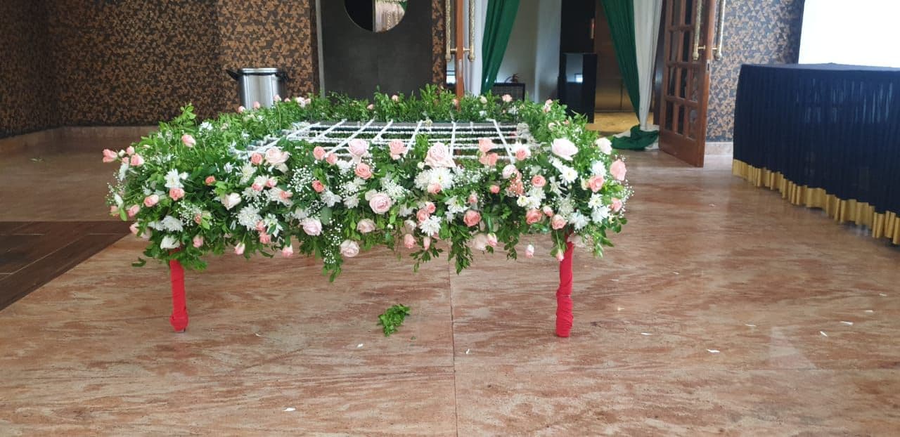 White flower chadar with green leaf border for a bridal entry