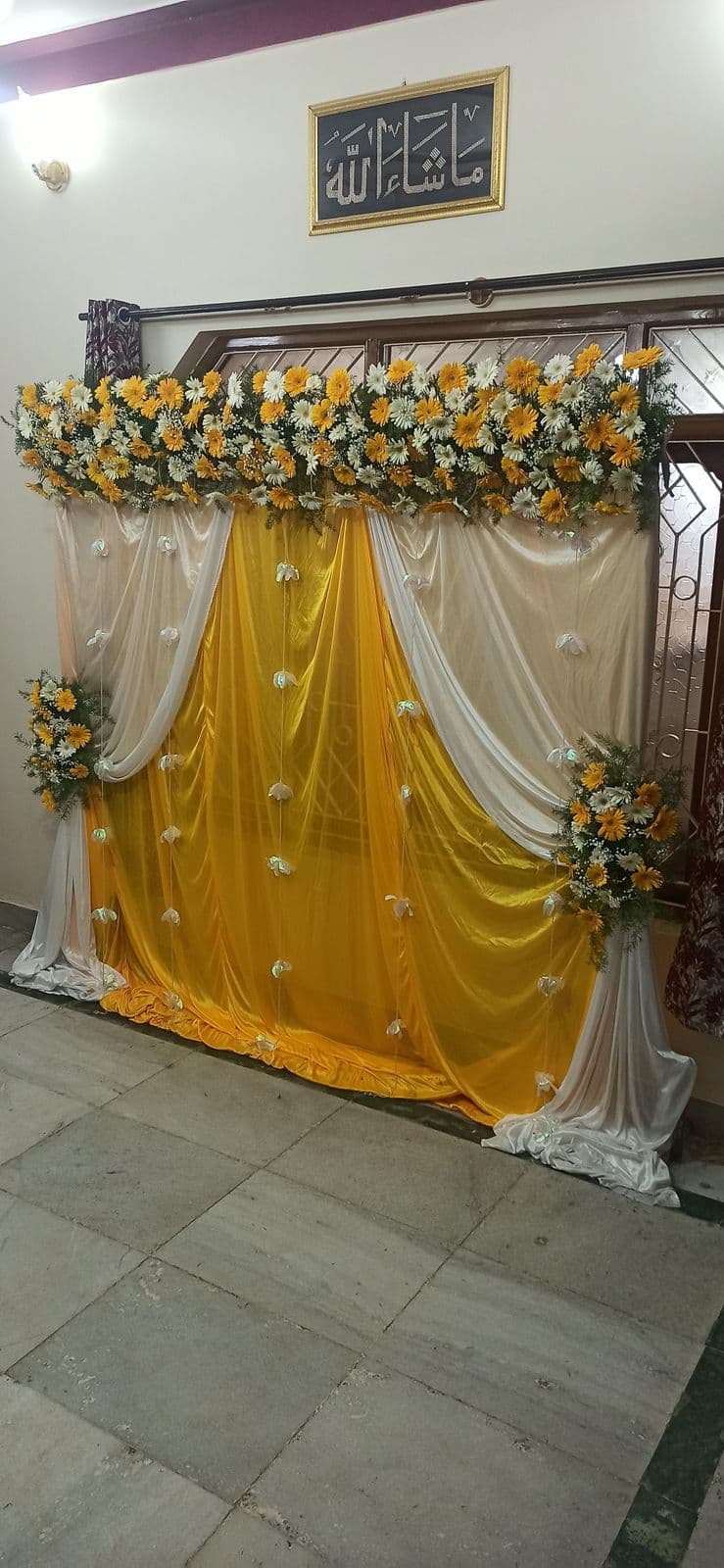 Yellow drape manjha haldi backdrop with sunflowers and framed calligraphy