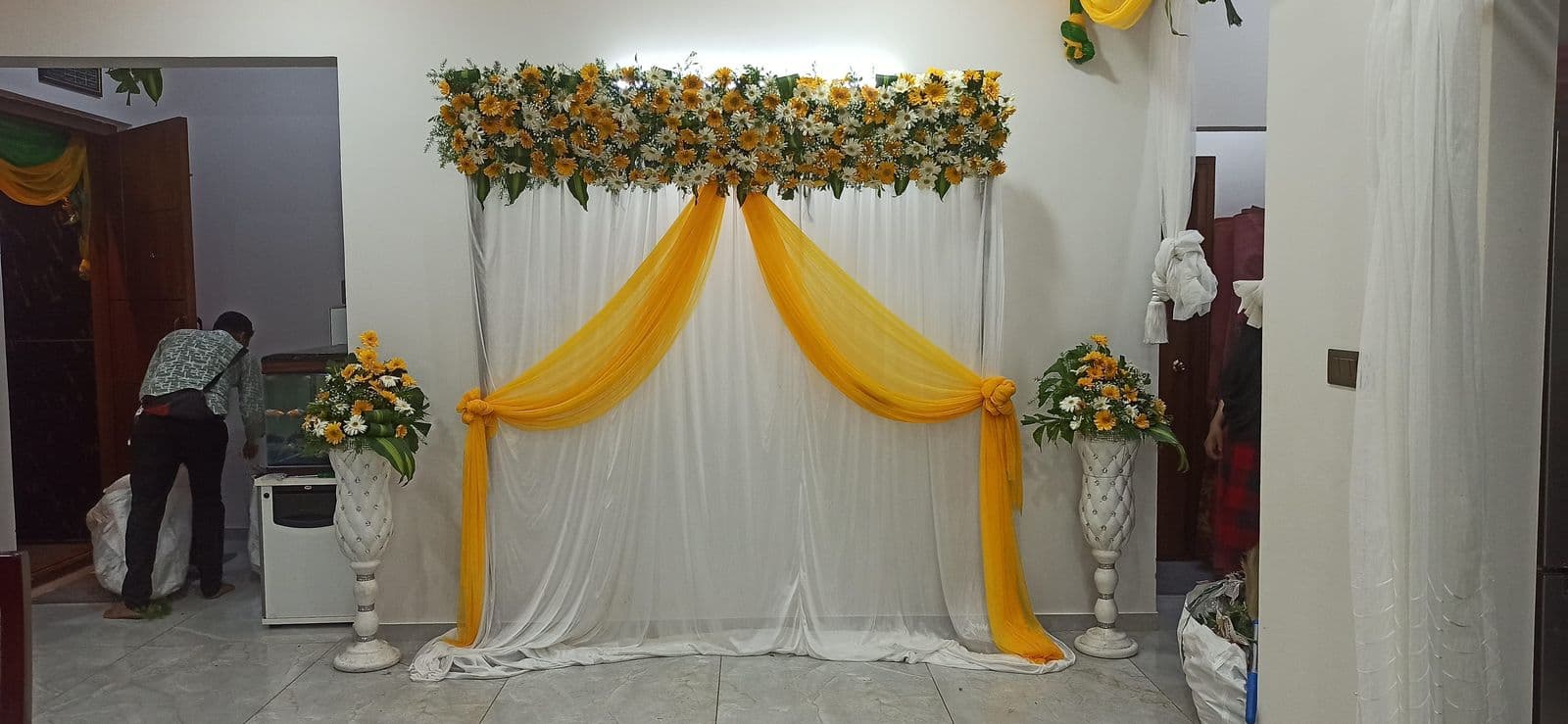 Compact yellow drape haldi backdrop with floral top
