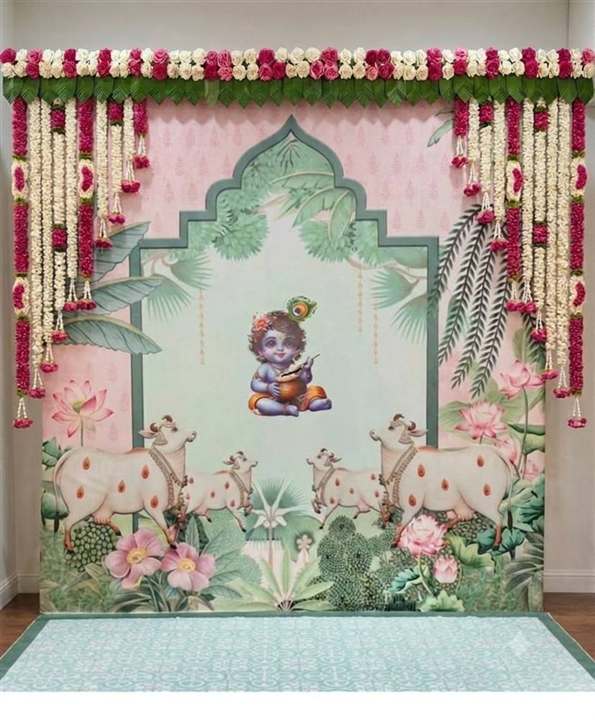 Krishna-themed baby shower backdrop with pastel florals and marigold hanging strands
