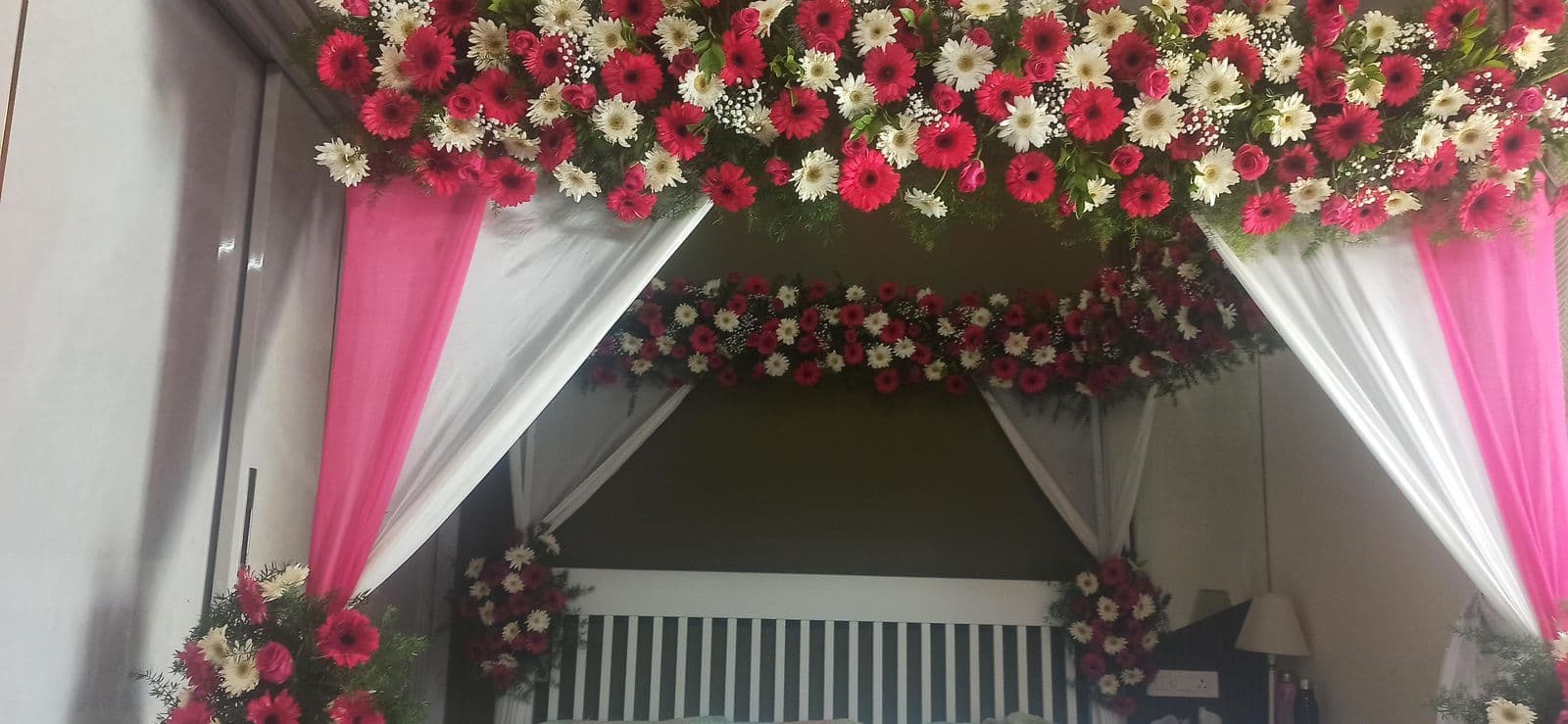 Bedroom canopy with pink drapes and mixed rose florals