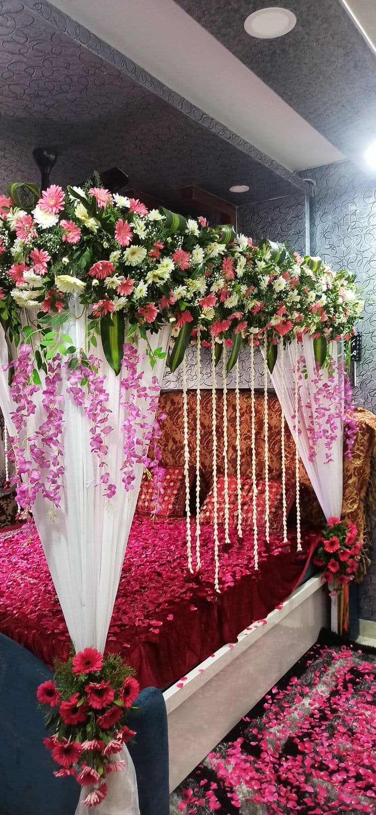 Bed canopy with wisteria strands and rose florals
